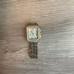 Gold women’s watch white face.